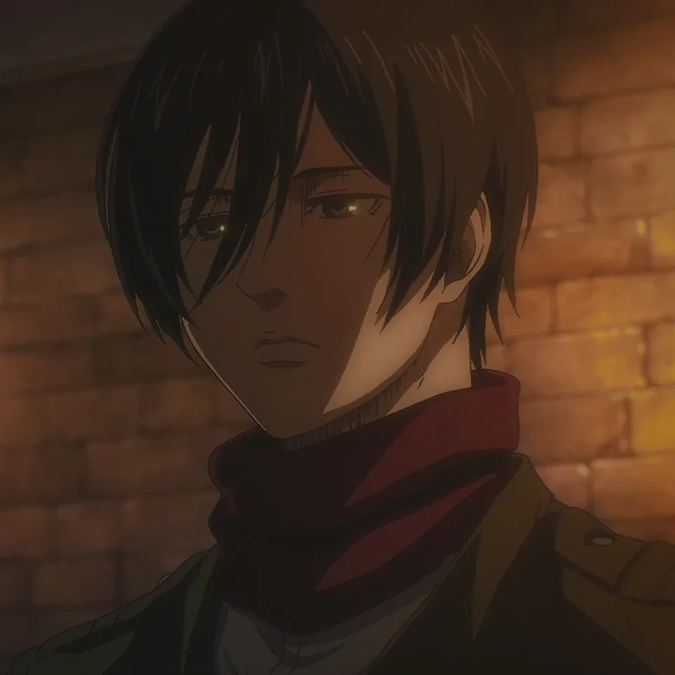 Portrait of a composed young woman with short black hair and dark eyes, a red scarf wrapped around her neck above a cadet uniform